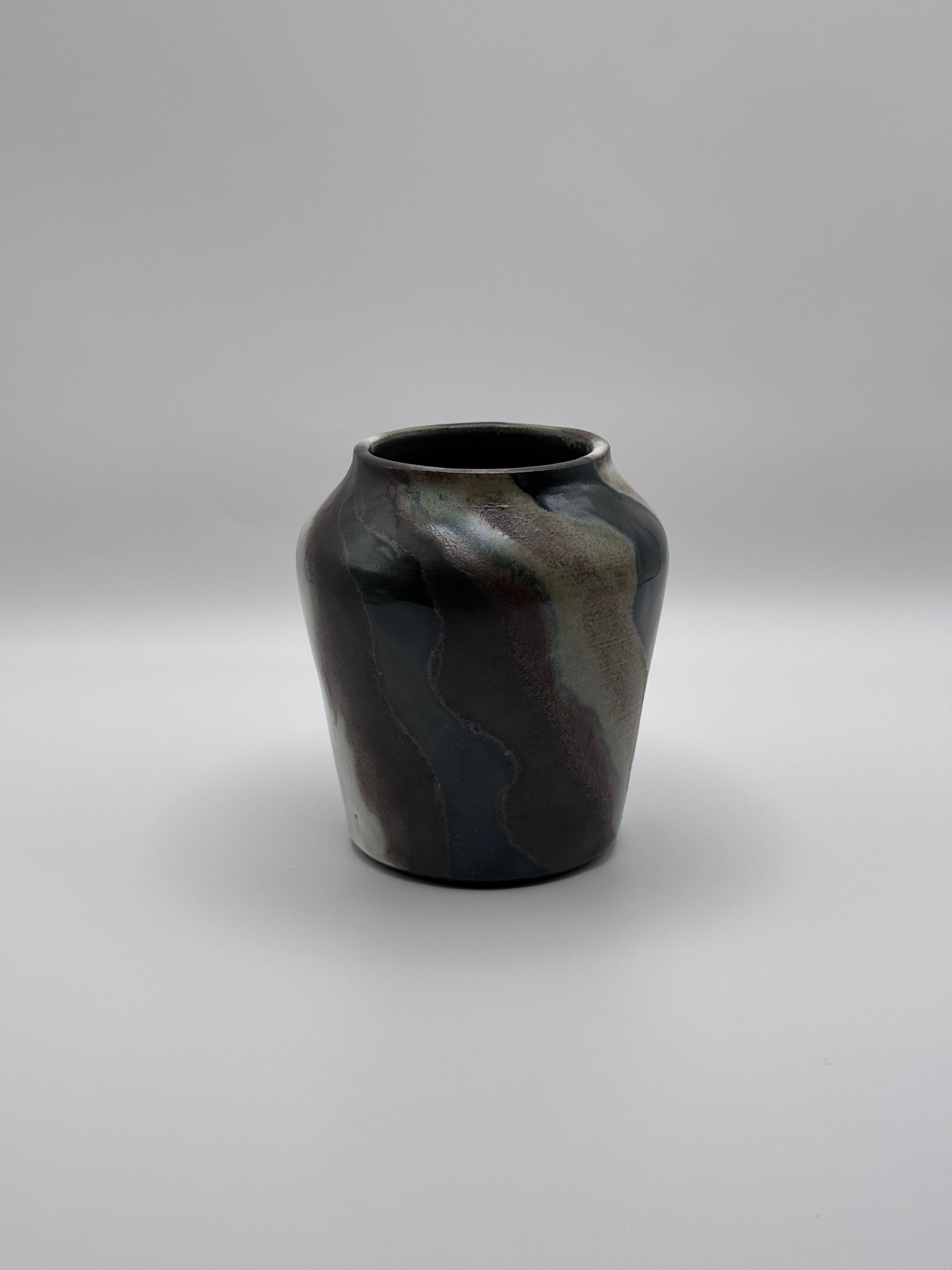 Tall ceramic vase with a defined shoulder and wide mouth, vertical streaks of dark brown, white, and green celadon glaze. View 3 of 3