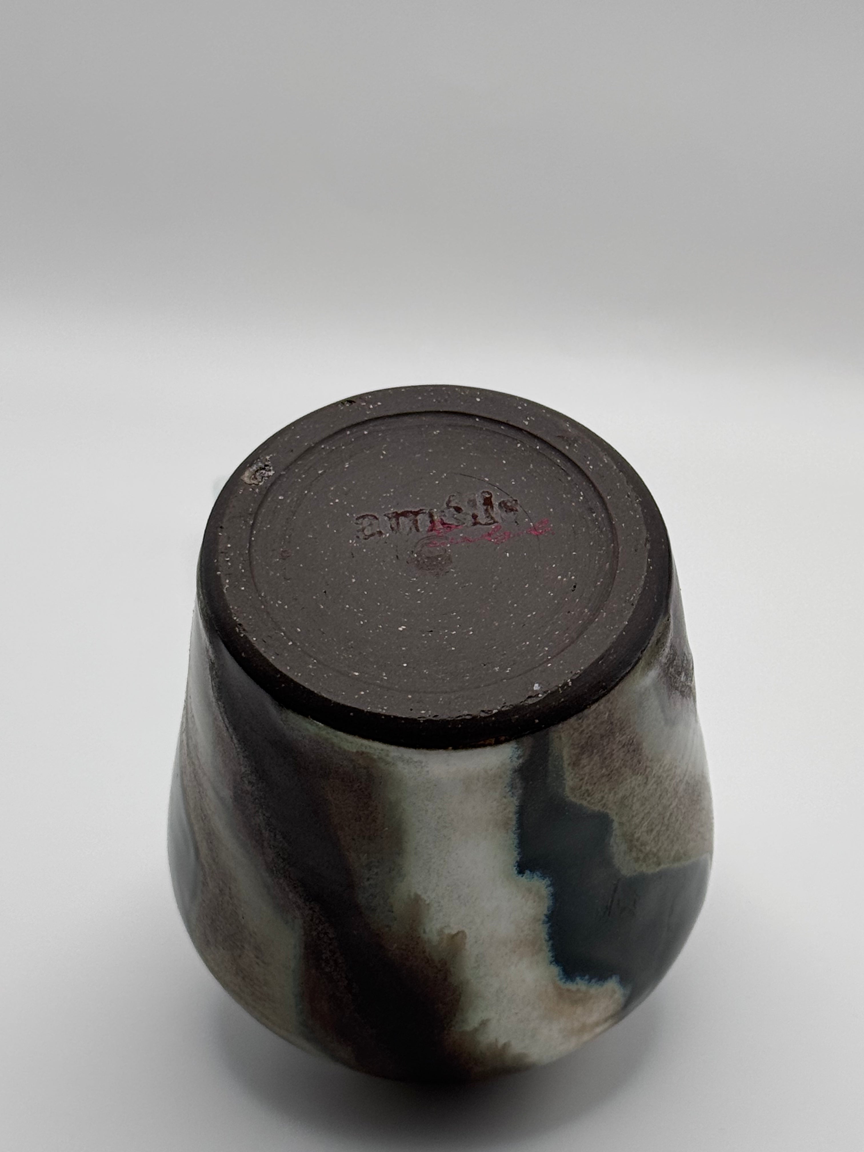 View of the foot of tall ceramic vase with a defined shoulder and wide mouth.